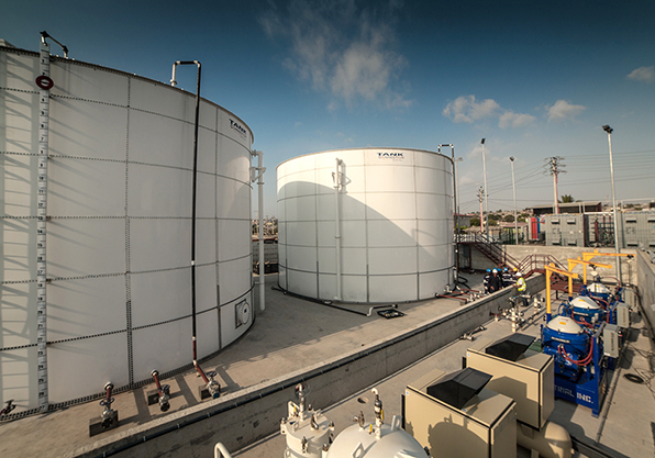 Two large fuel storage containers on power plant site